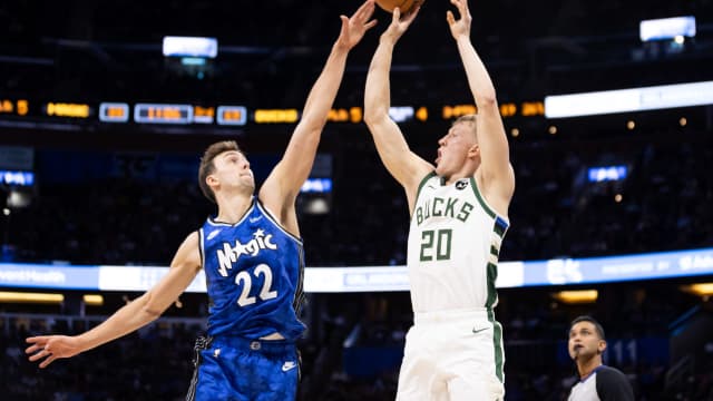 Orlando Magic forward Franz Wagner (22) attempts to block Milwaukee Bucks guard AJ Green (20)